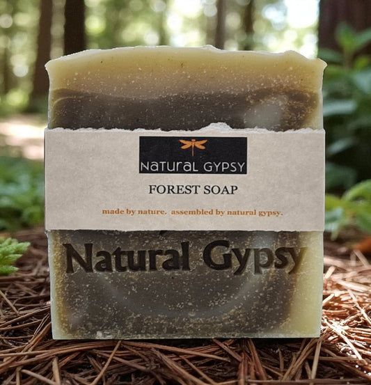Natural Gypsy Forest Soap bar made with organic nettle leaf powder and fir needle oil, set on a forest floor.